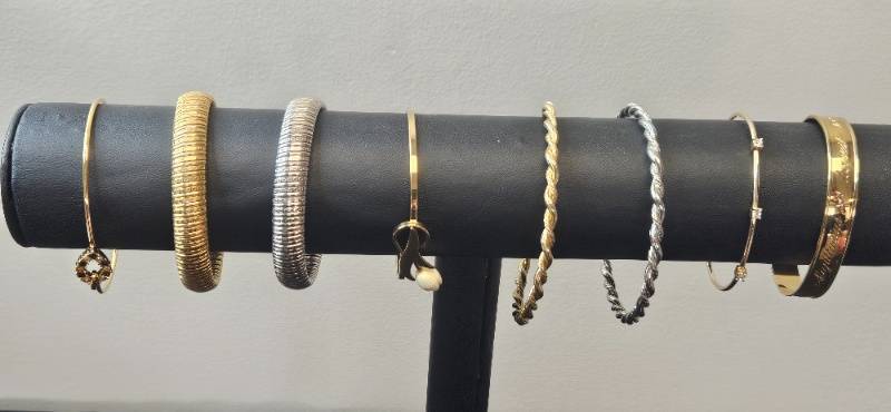 lot 95 image: Assorted Set of Gold Tone and Silver-Toned Bangles and Bracelets - display not inc