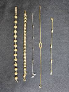 lot 202 image: Collection of Avon Gold Tone and Faux Pearl Bracelets