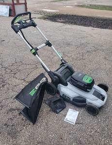 lot 25 image: EGO Power Self Propelled Lawnmower with Charger Works Well  Notice Consigner Brought us the Bagger and instructions after listing had started so that is also included in this lot. 1st Picture has been updated