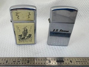 lot 17-C2025 image: 2 Vintage Slim Zippo Lighters (1) 1960 J.S. Stearns Contractor Advertising (1) Scrimshaw Whale 1990