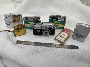 lot 26-C2025 image: 7 Assorted Vintage Lighters (2) Salem, (1) Marlboro Side Spin, (1) Mini with Chain (1) Camera Looking (1) Vernco (1) Smaller No Name