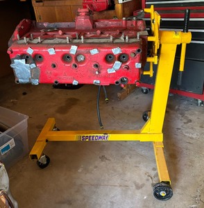 lot 129 image: Performance Tool 1000 Pound Capacity Engine Stand with Plymouth Flathead 6 Motor