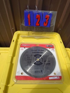 lot 123 image: New 10 180t carbide saw blade. 1 arbor. As shown.