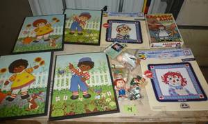 lot 14 image: Raggedy Ann needlepoint canvas, wall hangings and more