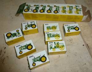lot 93 image: Collection of 8 mini John Deere tractors new in box