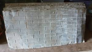 lot 107 image: FOUR pieces of barn tin with brick pattern