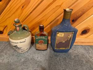 lot 151 image: Set of Vintage Whiskey Decanters Featuring Tullamore Dew, Shandon Bells, and Artistic Portrait