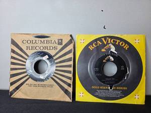 lot 108 image: Pair of Elvis Presley 45 RPM Records with Columbia and RCA Victor Sleeves