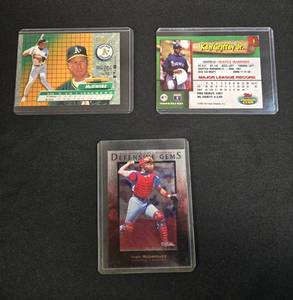 lot 114 image: Collection of 3 Baseball Cards Featuring Ivan Rodriguez, Ken Griffey Jr., and Mark McGwire