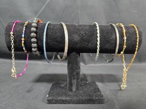 lot 261 image: Set of Beaded and Metal Bracelets on Display Stand