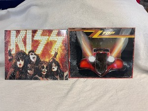 lot 145 image: Kiss and ZZ Top Tin Signs 16 x 12.5. New in Wrap.