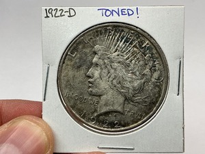 lot 20 image: 1922-D Toned Silver Peace Dollar