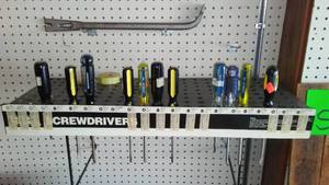 lot 83 image: Assorted Screwdrivers with peg board organizer and Pry Bar.