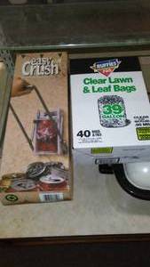 lot 128 image: 39 gal. Leaf Bags and Can Crusher.
