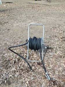 lot 15 image: Roll up Garden Hose Reel Cart with Wheels and Black Hose