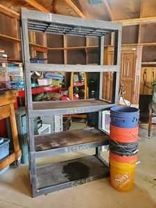 lot 40 image: Tall Solid Hard Plastic Shop Shelf w 5 gallon pails May need a good cleaning but it is in solid Condition