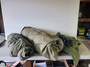 lot 41 image: Vintage Military Sleeping Bag and Canvas TarpsTents with rope and Stakes Marked