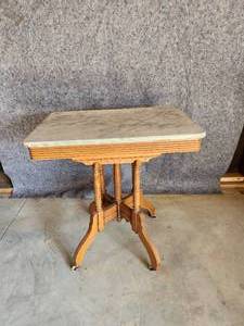lot 67 image: Solid Beautiful side table with great detail and marble top NOTICE Buyer is responsible for Loading and Removal 