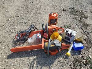 lot 173 image: Two Husqvarna Gas powered Chain saws and Misc Accessories one works as it should the other is for Parts or Repair