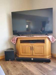 lot 263 image: 58 Hisene Roku TV with Visio Sound System, TV Sturdy Amish Oak Stand, and DVDs NOTICE Buyer is responsible for Loading and Removal 