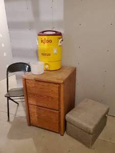 lot 289 image: Antique Stow-Away By Barnett foot Stool ottoman, Wooden File Cabinet, Igloo Cooler and more NOTICE Buyer is responsible for Loading and Removal 