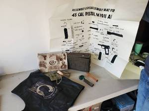 lot 309 image: Colt Gun Box, Box Only, POW leather Vest, 45 Cal Assembly & Disassembly Mat and More