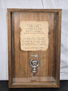 lot 9 image: Framed Plaque with Key and Cadillac Emblem