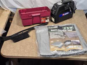 lot 105 image: Lot of Automotive and Utility Items including multi-purpose tarp measuring 8 x 10, a Campbell Hausfeld inflatorcompressor, a snow brush, and a toolbox.