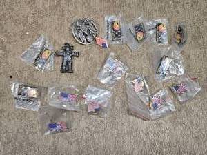 lot 114 image: Patriotic Pins and Figurines featuring designs such as the American flag and United We Stand with eagles. Some pins commemorate September 11, 2001