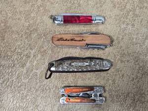 lot 115 image: Pocket Knives and Multitool with one labeled Eddie Bauer and another marked Kamp-King.