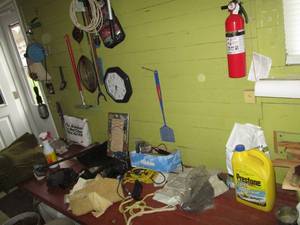 lot 215 image: Content on garage table and wall in...