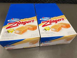 lot 341 image: Hostess Iced Vanilla Zingers Snack Cakes - 2 boxes of 6 Count each