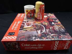 lot 34 image: COCA-COLA PUZZLE WITH COFFEE MUG AND CAN FOAM