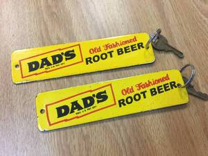 lot 186 image: Pair Vintage Dads Root Beer - Porcelain KeychainsCrate Badge