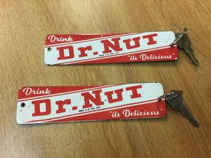 lot 187 image: Pair Vintage Dr Nut - Porcelain KeychainsCrate Badge
