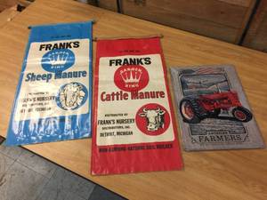 lot 261 image: Vintage Manure Bags  Metal Tractor Sign