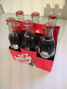 lot 199 image: (6) Unopened 2001 Fighting Sioux Football Champions Coke Bottles
