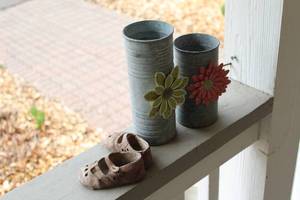 lot 16 image: Set of 2 Rustic Metal Flower Vases and Decorative Baby Shoes