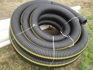 lot 11 image: Large roll of 6in plastic drain pip...