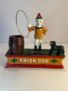 lot 31 image: Clown and Trick Dog cast iron mechanical bank. This bank is in good working condition.