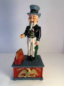 lot 27 image: Uncle Sam cast iron mechanical bank. This bank is in good working condition.