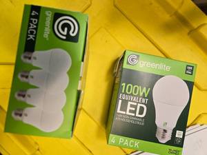 lot 84 image: Lot of 8 LED Greenlite 100W Equivalent Light Bulbs (4 packs in each of the two boxes) New