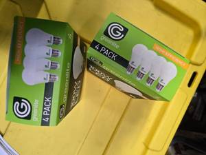 lot 107 image: Lot of 8 LED Greenlite 100W Equivalent Light Bulbs (4 packs in each of the two boxes) New