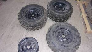 lot 69 image: 3 tires 4 rims look to be off a sid...