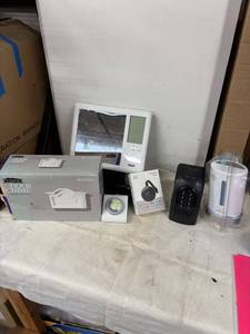 lot 212 image: Electronics Bundle Smart Thermostat, TV Buddy Caster, Door Chime, and More