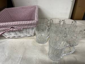 lot 128 image: Set of 7 Clear Glass Mugs with Diamond Cut Design and Wicker Basket
