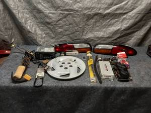 lot 30 image: Automotive Parts Lot with Tail Lights, Oil Filter and More