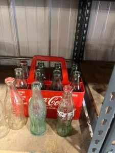 lot 48 image: coke bottles and Carrier 12 bottles