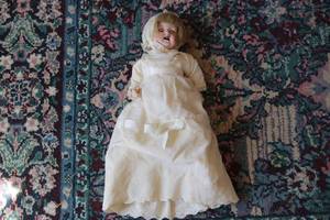 lot 563 image: Antique doll in white dress...