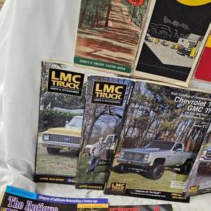 lot 180 image: Box of LMC Truck Parts Catalogs & Antique Antique Motorcycle Magazines along with Early MN Maps